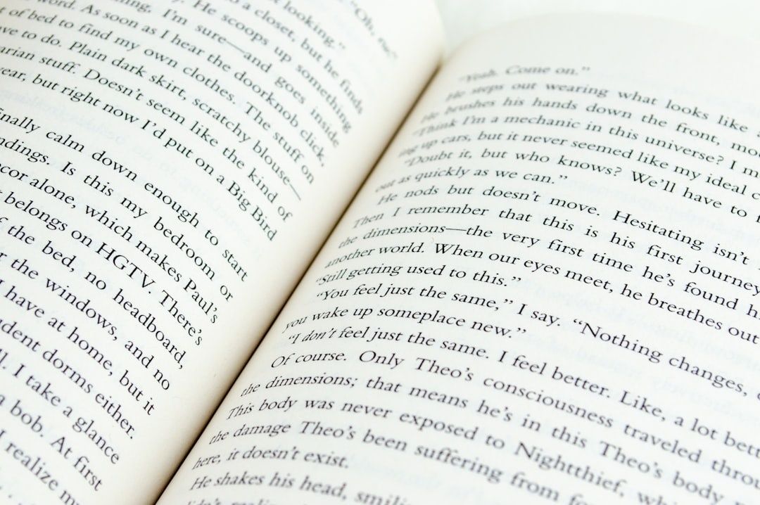 Open novel showing dense prose across two angled pages